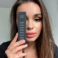 Model covering her eye with a Nanobrow serum box