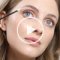 A model applying eyelash conditioner and a play button in the middle